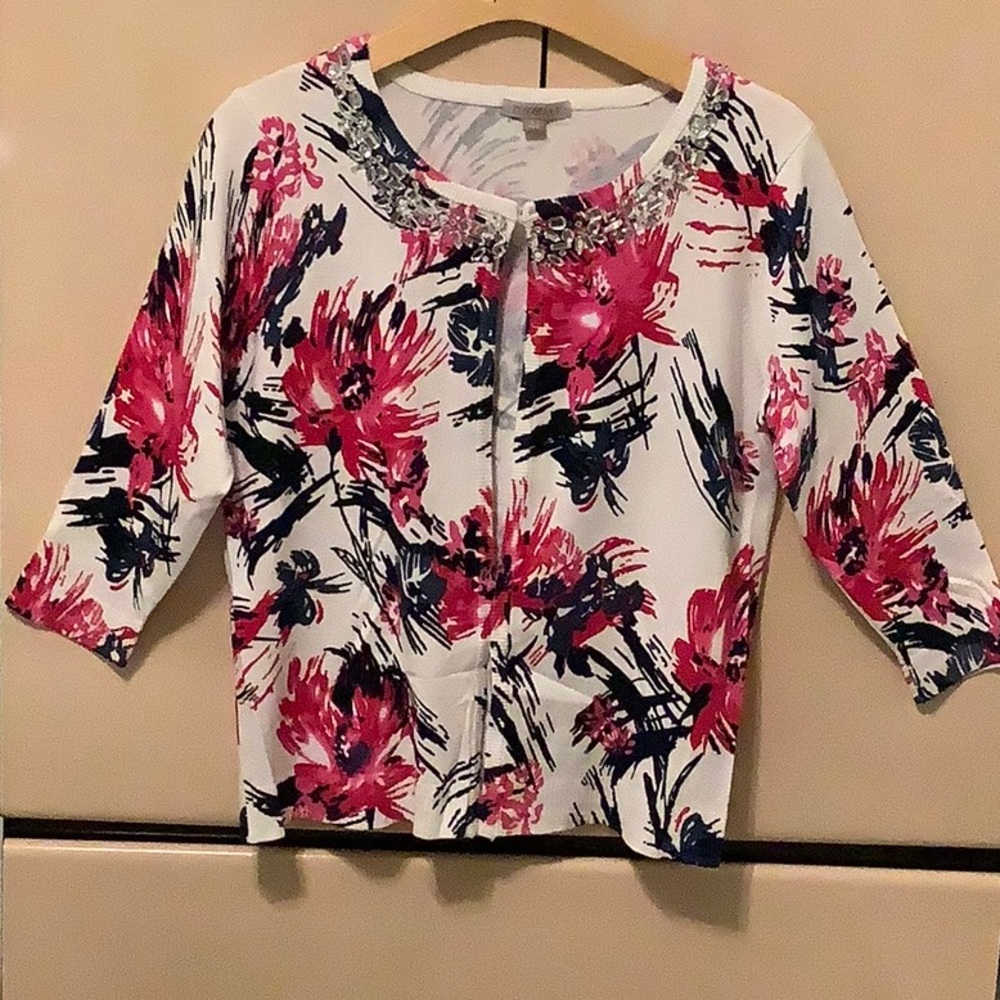 Cardigan style sweater with clasp at top, falls open at bottom